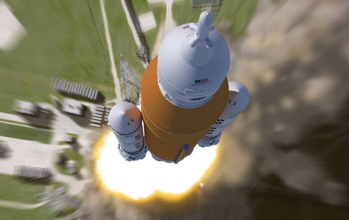 Aerial view looking down at NASA's Artemis I rocket during liftoff.